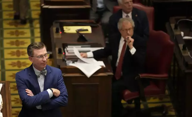 Rep. Ryan Williams, R-Cookeville, left, listens to debate of his bill to allow some teachers to be armed in schools on the House floor during a legislative session Tuesday, April 23, 2024, in Nashville, Tenn. (AP Photo/George Walker IV)