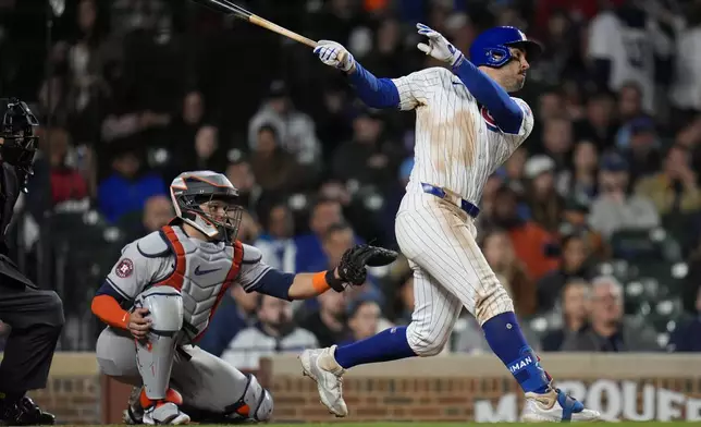 Chicago Cubs' Mike Tauchman hits a home run during the eighth inning of a baseball game against the Houston Astros, Tuesday, April 23, 2024, in Chicago. (AP Photo/Erin Hooley)
