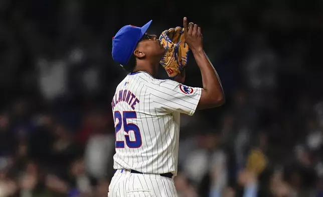 Chicago Cubs closing pitcher Yency Almonte celebrates his team's 7-2 win over the Houston Astros in a baseball game Tuesday, April 23, 2024, in Chicago. (AP Photo/Erin Hooley)