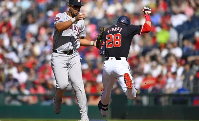 Houston Astros first base José Abreu, left, tags Washington Nationals Thomas for the second out at first base during the first inning of a baseball game at Nationals Park, Saturday, April 20, 2024, in Washington. (AP Photo/John McDonnell)