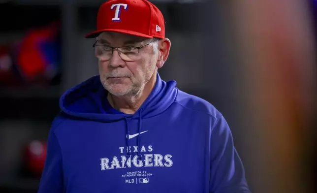 Texas Rangers manager Bruce Bochy walks through the dugout after the eighth inning of a baseball game against the Houston Astros, Monday, April 8, 2024, in Arlington, Texas. (AP Photo/Gareth Patterson)