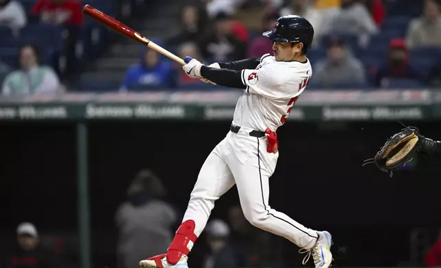 Cleveland Guardians' Steven Kwan follows through on a two-run double against the Oakland Athletics during the fifth inning of a baseball game Friday, April 19, 2024, in Cleveland. (AP Photo/Nick Cammett)