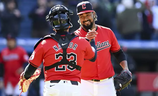 Cleveland Guardians relief pitcher Emmanuel Clase, right, and Bo Naylor (23) celebrate after their win over the Oakland Athletics in a baseball game, Sunday, April 21, 2024, in Cleveland. (AP Photo/Nick Cammett)