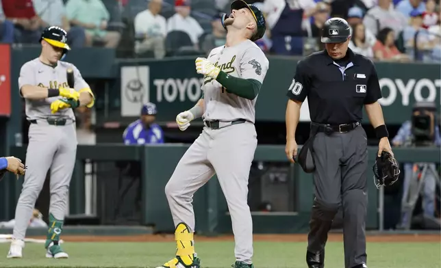 Oakland Athletics' Seth Brown scores on his solo home run against the Texas Rangers during the second inning of a baseball game Thursday, April 11, 2024, in Arlington, Texas. (AP Photo/Michael Ainsworth)
