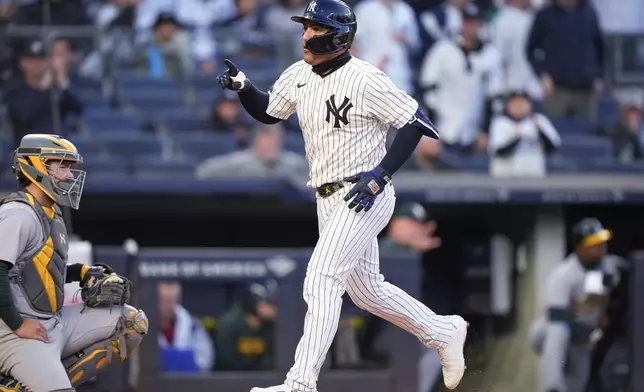 New York Yankees' Jose Trevino crosses home plate after hitting a home run against the Oakland Athletics during the second inning of a baseball game Thursday, April 25, 2024, in New York. (AP Photo/Bryan Woolston)
