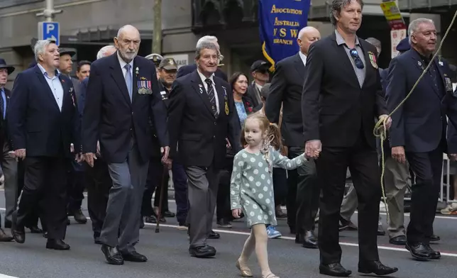 A young girl marches during the Anzac Day parade in central the business district of Sydney, Australia, Thursday, April 25, 2024. (AP Photo/Mark Baker)