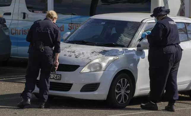 Police forensic officers inspect a car outside the Christ the Good Shepherd Church in suburban Wakely in western Sydney, Australia, Tuesday, April 16, 2024. Australian police say a knife attack in Sydney that wounded a bishop and a priest during a church service as horrified worshippers watched online and in person, and sparked a riot was an act of terrorism. (AP Photo/Mark Baker)