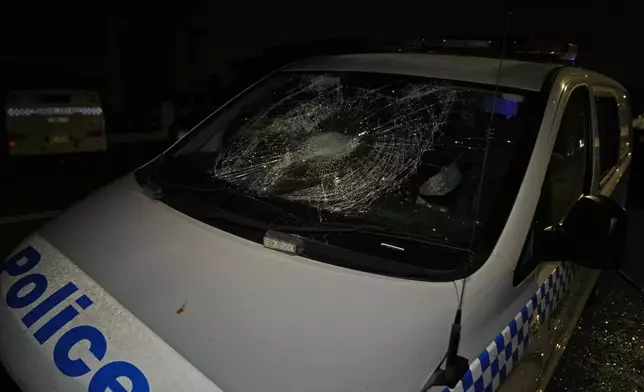 A Police car is seen vandalised outside a church where a bishop and churchgoers were reportedly stabbed in Sydney Australia, Monday, April 15, 2024. (AP Photo/Mark Baker)
