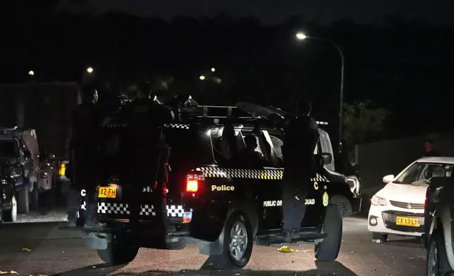 Riot police drives away after securing outside a church where a bishop and churchgoers were reportedly stabbed in Sydney Australia, Monday, April 15, 2024. Police in Australia say a man has been arrested after a bishop and churchgoers were stabbed in the church. There are no life-threatening injuries. (AP Photo/Mark Baker)