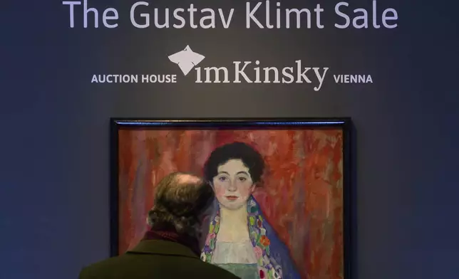 A man looks at the painting 'Portrait of Fräulein Lieser' by Austrian painter Gustav Klimt prior to an auction, in Vienna, Wednesday, April 24, 2024. A portrait of a young woman by Gustav Klimt that was long believed to be lost has been sold at an auction in Vienna for 30 million euros ($32 million). The Austrian modernist artist started work on the “Portrait of Fräulein Lieser” in 1917, the year before he died, and it is one of his last works. (AP Photo/Christian Bruna)