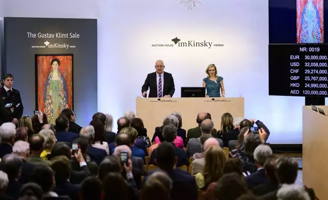 Auctioneer Michael Kovacek declares the sale of the painting 'Portrait of Fräulein Lieser' by Austrian painter Gustav Klimt during an auction, in Vienna, Wednesday, April 24, 2024. A portrait of a young woman by Gustav Klimt that was long believed to be lost has been sold at an auction in Vienna for 30 million euros ($32 million). The Austrian modernist artist started work on the “Portrait of Fräulein Lieser” in 1917, the year before he died, and it is one of his last works. (AP Photo/Christian Bruna)