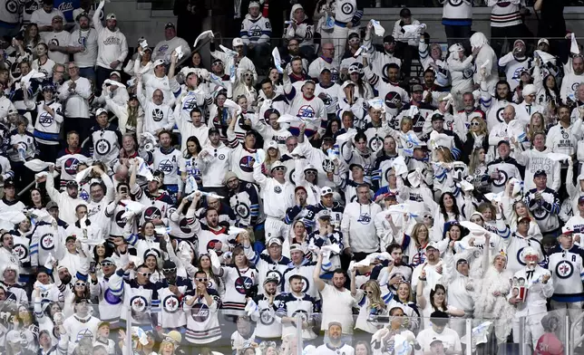 Winnipeg Jets fans cheer after their team scored against the Colorado Avalanche during the second period in Game 1 of an NHL hockey Stanley Cup first-round playoff series in Winnipeg, Manitoba, Sunday April 21, 2024. (Fred Greenslade/The Canadian Press via AP)