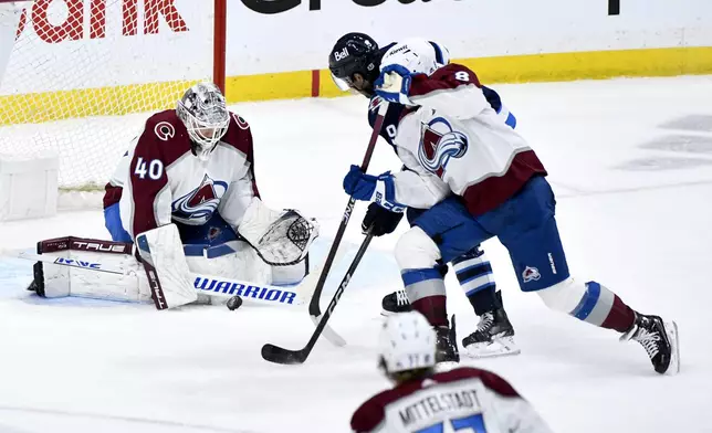 Colorado Avalanche goaltender Alexandar Georgiev (40) makes a save against Winnipeg Jets' Alex Iafallo (9) during the third period in Game 2 of an NHL hockey Stanley Cup first-round playoff series Tuesday, April 23, 2024, in Winnipeg, Manitoba. (Fred Greenslade/The Canadian Press via AP)