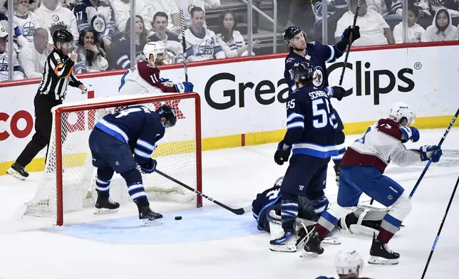 Colorado Avalanche players celebrates the goal by Zach Parise against the Winnipeg Jets during the second period in Game 2 of an NHL hockey Stanley Cup first-round playoff series Tuesday, April 23, 2024, in Winnipeg, Manitoba. (Fred Greenslade/The Canadian Press via AP)