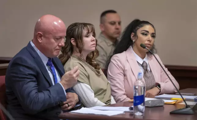 Hannah Gutierrez-Reed, center, with her attorney Jason Bowles, left, and paralegal Carmella Sisneros prepare for a sentencing hearing in state district court in Santa Fe, N.M., on Monday April 15, 2024. Gutierrez-Reed, the armorer on the set of the Western film "Rust," was sentenced to 18 months in prison for involuntary manslaughter in the death of cinematographer Halyna Hutchins, who was fatally shot by Alec Baldwin in 2021. (Eddie Moore/The Albuquerque Journal via AP, Pool)