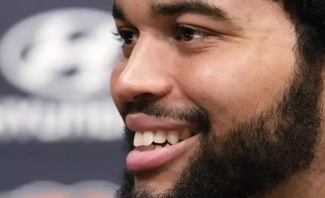 Chicago Bears No. 1 draft pick quarterback Caleb Williams smiles as he listens to reporters during an NFL football news conference in Lake Forest, Ill., Friday, April 26, 2024. (AP Photo/Nam Y. Huh)