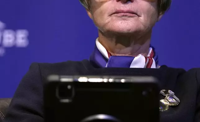 Activist Gloria von Thurn-und-Taxis looks at her electronic device as she attends the National Conservatism conference in Brussels, Wednesday, April 17, 2024. (AP Photo/Virginia Mayo)