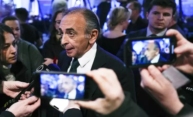French politician Eric Zemmour, center, speaks with the media as he arrives for the National Conservatism conference in Brussels, Wednesday, April 17, 2024. (AP Photo/Virginia Mayo)