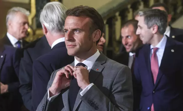 French President Emmanuel Macron, center, prior to a group photo during a reception at the Royal Palace prior to an EU summit in Brussels, Wednesday, April 17, 2024. (Olivier Hoslet, Pool Photo via AP)