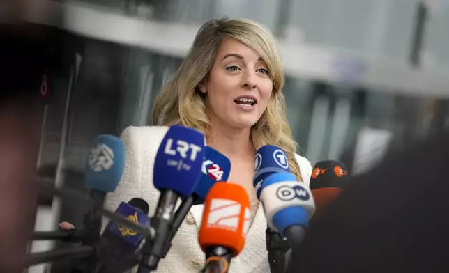 Canada's Foreign Minister Melanie Joly speaks with the media as she arrives for a meeting of NATO foreign ministers at NATO headquarters in Brussels, Wednesday, April 3, 2024. NATO foreign ministers gathered in Brussels on Wednesday to debate plans to provide more predictable, longer-term support to Ukraine. (AP Photo/Virginia Mayo)