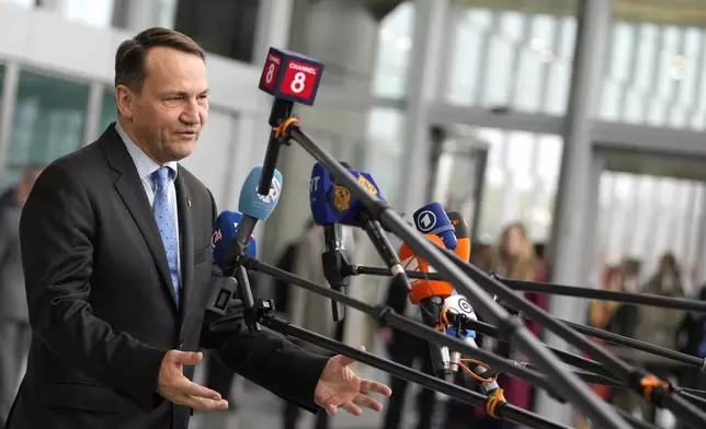 Poland's Foreign Minister Radoslaw Sikorski speaks with the media as he arrives for a meeting of NATO foreign ministers at NATO headquarters in Brussels, Wednesday, April 3, 2024. NATO foreign ministers gathered in Brussels on Wednesday to debate plans to provide more predictable, longer-term support to Ukraine. (AP Photo/Virginia Mayo)