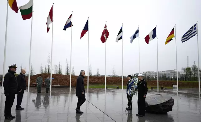NATO Secretary General Jens Stoltenberg, center, walks toward honor guards during a wreath laying ceremony at NATO headquarters in Brussels, Thursday, April 4, 2024. NATO celebrates on Thursday 75 years of collective defense across Europe and North America as Russia's war on Ukraine enters its third year. (AP Photo/Virginia Mayo)