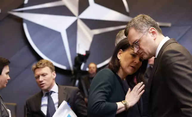 Germany's Foreign Minister Annalena Baerbock, second right, speaks with Ukraine's Foreign Minister Dmytro Kuleba during a meeting of the NATO-Ukraine Council at NATO headquarters in Brussels, Thursday, April 4, 2024. NATO celebrates on Thursday 75 years of collective defense across Europe and North America as Russia's war on Ukraine enters its third year. (AP Photo/Geert Vanden Wijngaert)