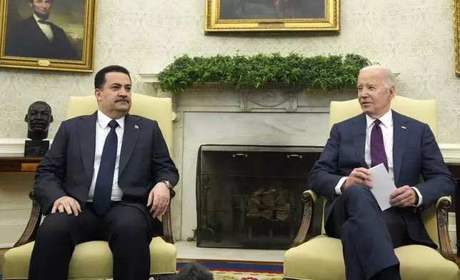 President Joe Biden, right, meets with Iraq's Prime Minister Shia al-Sudani in the Oval Office of the White House, Monday, April 15, 2024, in Washington. (AP Photo/Alex Brandon)