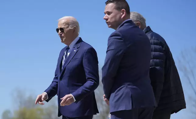 President Joe Biden, from left, walks with County Executive Ryan McMahon and Senate Majority Leader Chuck Schumer, D-N.Y., as he arrives at Hancock Field Air National Guard Base, Thursday, April 25, 2024, in Syracuse, N.Y. (AP Photo/Evan Vucci)
