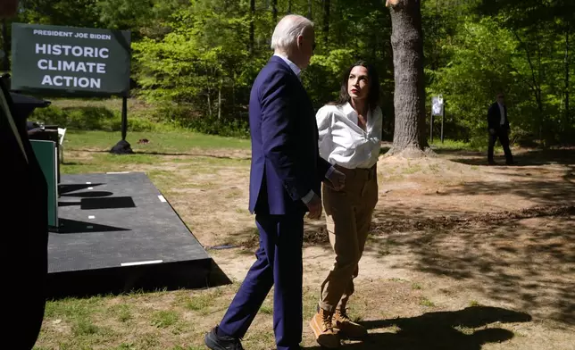 President Joe Biden, left, and Rep. Alexandria Ocasio-Cortez, D-N.Y. are pictured after Biden spoke at Prince William Forest Park on Earth Day, Monday, April 22, 2024, in Triangle, Va. Biden announced $7 billion in federal grants to provide residential solar projects serving low- and middle-income communities and expanding his American Climate Corps green jobs training program. (AP Photo/Manuel Balce Ceneta)
