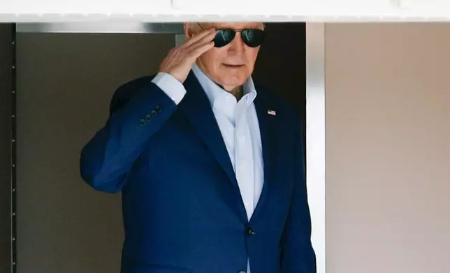 President Joe Biden returns a salute from Air Force One at Andrews Air Force Base, Md., Thursday, April 18, 2024. The President is traveling to Philadelphia. (AP Photo/Luis M. Alvarez)