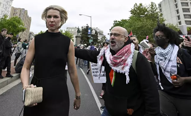 Demonstrators protest the Israel-Hamas war as a guest, left, arrives at the White House Correspondents' Association Dinner at the Washington Hilton, Saturday April 27, 2024, in Washington. (AP Photo/Terrance Williams)