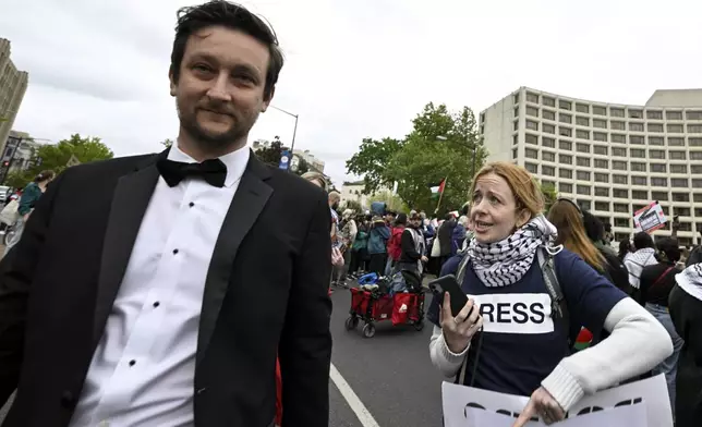 A White House Correspondents' Association Dinner attendee, left, is confronted by a demonstrator during a pro-Palestinian protest over the Israel-Hamas war, Saturday April 27, 2024, outside the Washington Hilton in Washington. (AP Photo/Terrance Williams)