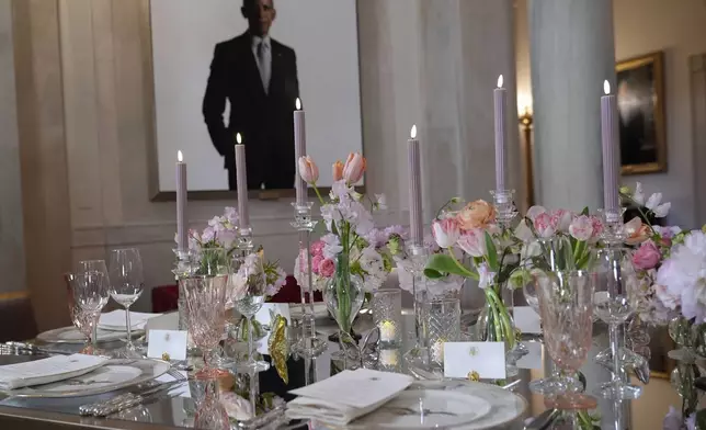 Tables are decorated during a press preview at the White House in Washington, Tuesday, April 9, 2024, for the State Dinner for Japan's Prime Minister Fumio Kishida on Wednesday. A portrait of former President Barrack Obama hangs in the White House, rear. (AP Photo/Susan Walsh)