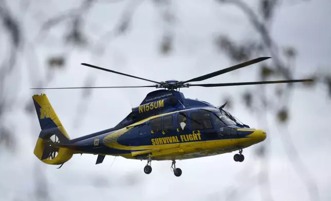 A University of Michigan Health Systems Survival Flight responds to the Swan Creek Boat Club after a driver crashed a vehicle through a building where a children's birthday party was taking place, Saturday, April 20, 2024, in Berlin Township, Mich. (Kathleen Kildee/Detroit News via AP)