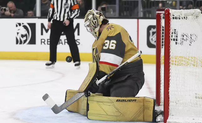 Vegas Golden Knights goaltender Logan Thompson makes a save against the Chicago Blackhawks during the third period of an NHL hockey game Tuesday, April 16, 2024, in Las Vegas. (AP Photo/Ian Maule)