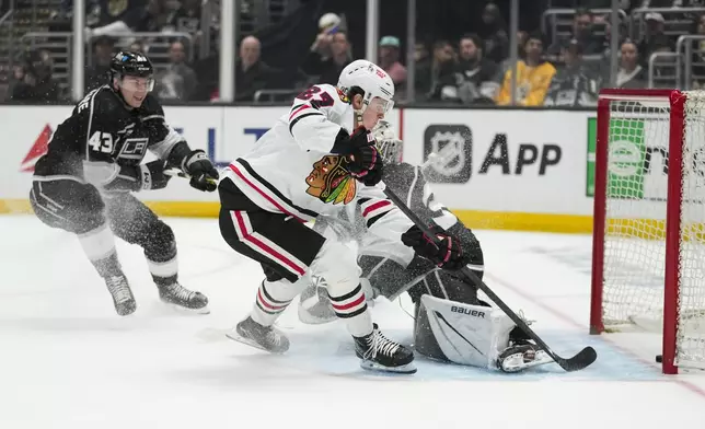 Chicago Blackhawks left wing Lukas Reichel (27) scores against Los Angeles Kings defenseman Jacob Moverare (43) and goaltender Cam Talbot (39) during the first period of an NHL hockey game Thursday, April 18, 2024, in Los Angeles. (AP Photo/Ashley Landis)