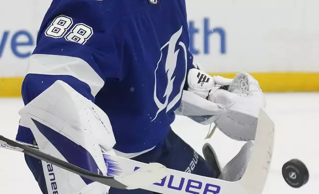 Tampa Bay Lightning goaltender Andrei Vasilevskiy makes a stick save on a shot by the Columbus Blue Jackets during the first period of an NHL hockey game Tuesday, April 9, 2024, in Tampa, Fla. (AP Photo/Chris O'Meara)