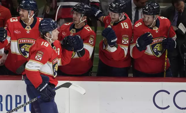 Florida Panthers left wing Matthew Tkachuk (19) is congratulated by his teammates after scoring a goal at the start of the first period of an NHL hockey game against the Columbus Blue Jackets, Thursday, April 11, 2024, in Sunrise, Fla. (AP Photo/Marta Lavandier)