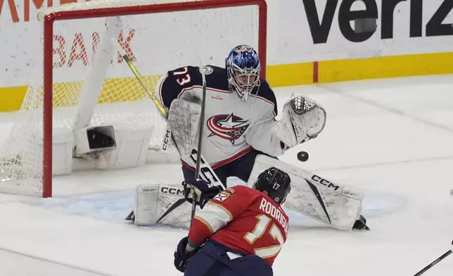 Columbus Blue Jackets goaltender Jet Greaves (73) stops a shot on goal by Florida Panthers center Evan Rodrigues (17) during the first period of an NHL hockey game, Thursday, April 11, 2024, in Sunrise, Fla. (AP Photo/Marta Lavandier)