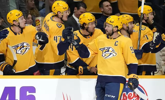 Nashville Predators' Roman Josi (59) is congratulated after scoring a goal against the Columbus Blue Jackets during the first period of an NHL hockey game Saturday, April 13, 2024, in Nashville, Tenn. (AP Photo/Mark Humphrey)