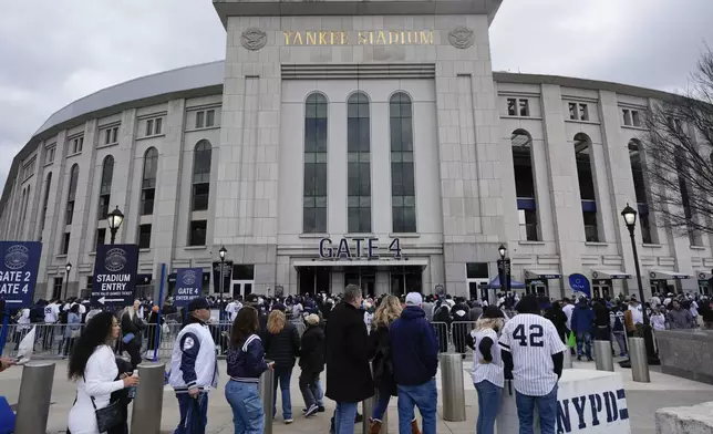 Fans line up to enter Yankee Stadium before the home opener baseball game against the Toronto Blue Jays Friday, April 5, 2024, in New York. (AP Photo/Seth Wenig)