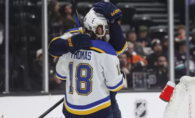 St. Louis Blues center Robert Thomas (18) celebrates with St. Louis Blues center Brayden Schenn (10) after scoring a goal during the second period of an NHL hockey game against the Anaheim Ducks Sunday, April 7, 2024, in Anaheim, Calif. (AP Photo/Yannick Peterhans)