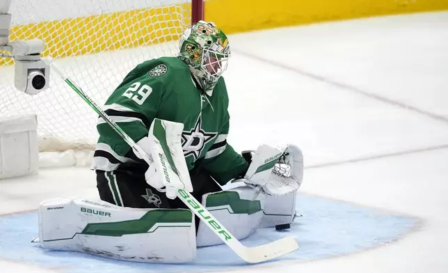 Dallas Stars goaltender Jake Oettinger blocks a St. Louis Blues shot during the second period of an NHL hockey game in Dallas, Wednesday, April 17, 2024. (AP Photo/Tony Gutierrez)