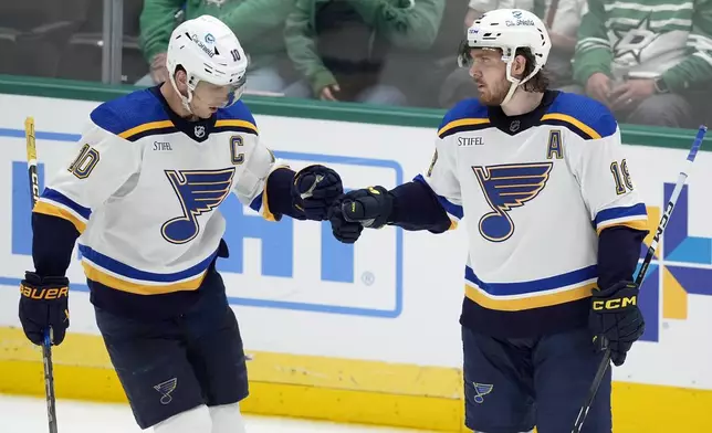 St. Louis Blues' Brayden Schenn (10) and Robert Thomas (18) celebrate after Thomas scored against the Dallas Stars during the second period of an NHL hockey game Wednesday, April 17, 2024. (AP Photo/Tony Gutierrez)