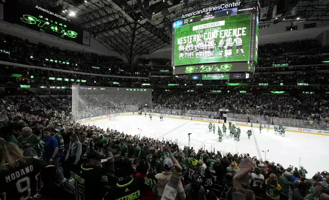 Fans cheer after the Dallas Stars won in a shootout during an NHL hockey game against the St. Louis Blues in Dallas, Wednesday, April 17, 2024. With the win the Stars clinched the top seed in the Western Conference. (AP Photo/Tony Gutierrez)