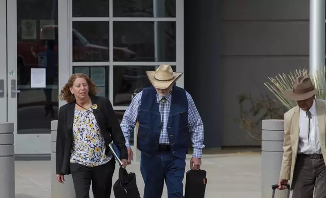 FILE - George Alan Kelly exits the Santa Cruz County Courthouse with defense attorney Kathy Lowthorp after the first day of his trial in Santa Cruz County Superior Court Friday, March 22, 2024 in Nogales, Ariz. Jurors in the case of the Arizona rancher Kelly charged with fatally shooting a migrant on his property visited the scene of the killing as the third week of the trial wrapped up. The jurors on Thursday, April 11, 2024, viewed various locations at Kelly's ranch, as well as a section of the U.S.-Mexico border. (Angela Gervasi/Nogales International, via AP, File)