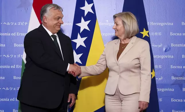 Hungarian Prime Minister Viktor Orban, left, shakes hands with the President of the Council of Ministers of Bosnia and Herzegovina Borjana Kristo prior to their meeting in Sarajevo, Bosnia, Thursday, April 4, 2024. (AP Photo)