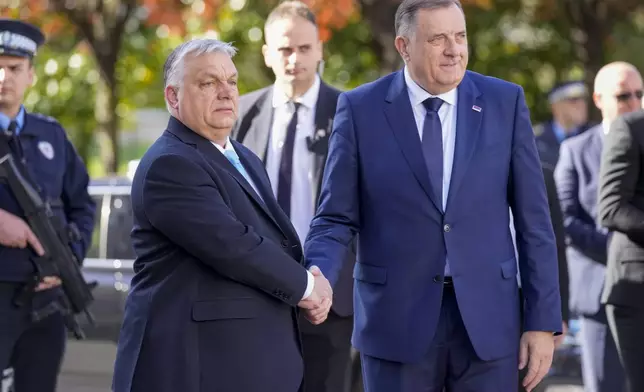 Bosnian Serb leader Milorad Dodik, right, welcomes Hungary's Prime Minister Viktor Orban, in Banja Luka, Bosnia, Friday, April 5, 2024. (AP Photo/Darko Bandic)
