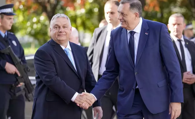 Bosnian Serb leader Milorad Dodik, right, welcomes Hungary's Prime Minister Viktor Orban, in Banja Luka, Bosnia, Friday, April 5, 2024. (AP Photo/Darko Bandic)